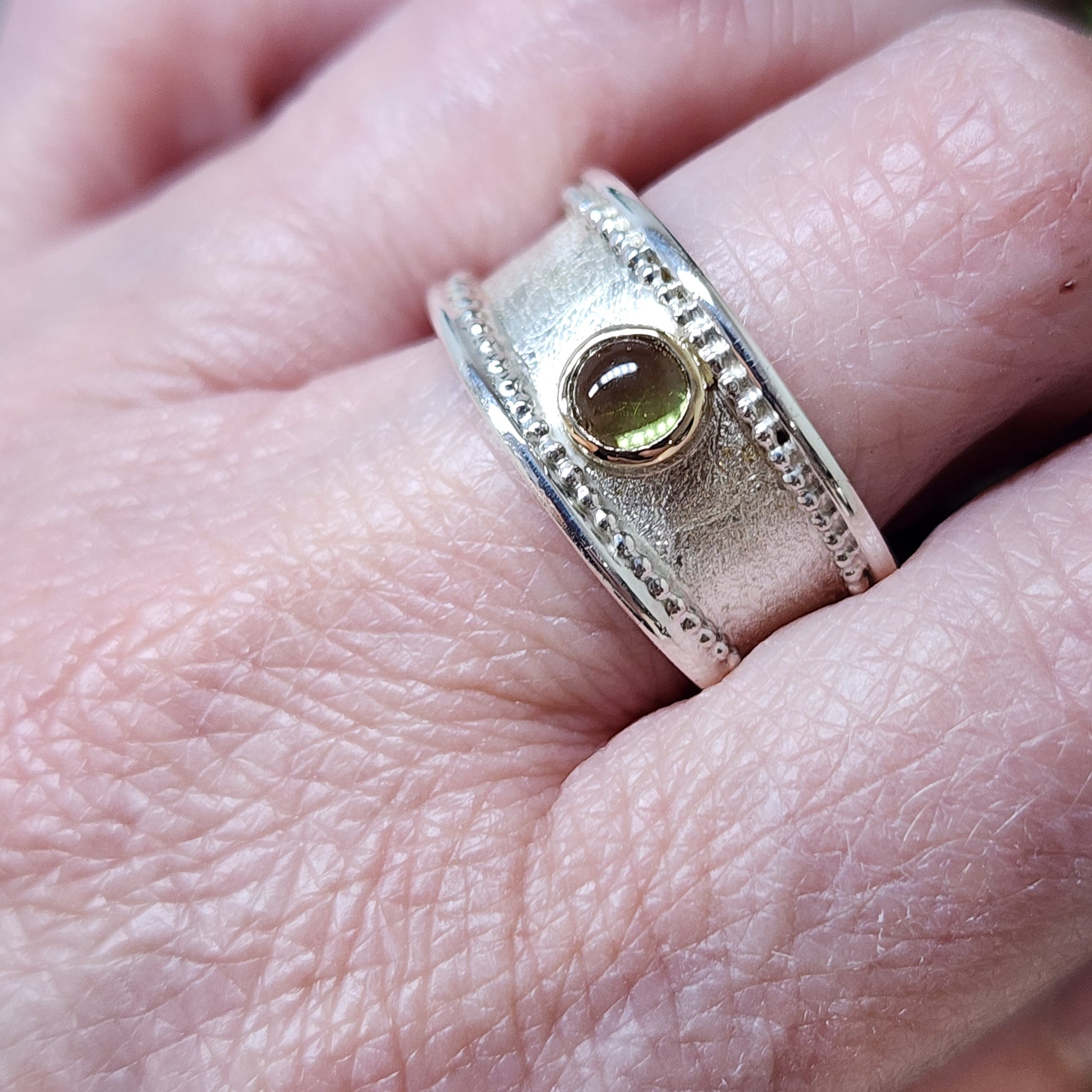 Handmade Sterling silver, gold and Peridot (August birthstone)ring. Size P1/2 but can be altered a little either way, hallmarked and Free UK postage.
